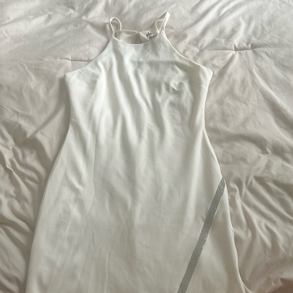 White cocktail dress with silver embellishment along the bottom hem, worn once.